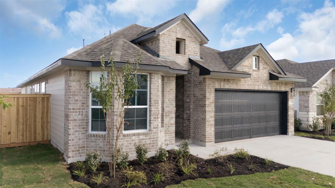 French provincial home with roof with shingles, driveway, brick siding, and an attached garage