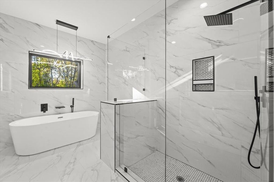 Bathroom featuring shower with separate bathtub and tile walls