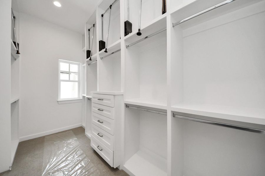 Customized walk-in closet with built-in storage features. Customized walk-in closet with built-in storage features.