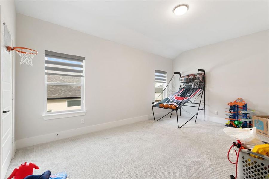 Game room with carpet, healthy amount of natural light, and lofted ceiling