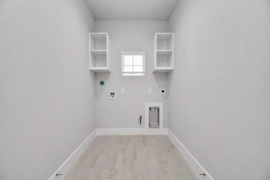 A perfect blend of functionality and comfort. Capture the essence of easy living with a first-floor laundry room, thoughtfully equipped with shelving for effortless organization. Both electric and gas connections available. A perfect blend of functionality and comfort. Capture the essence of easy living with a first-floor laundry room, thoughtfully equipped with shelving for effortless organization. Both electric and gas connections available.