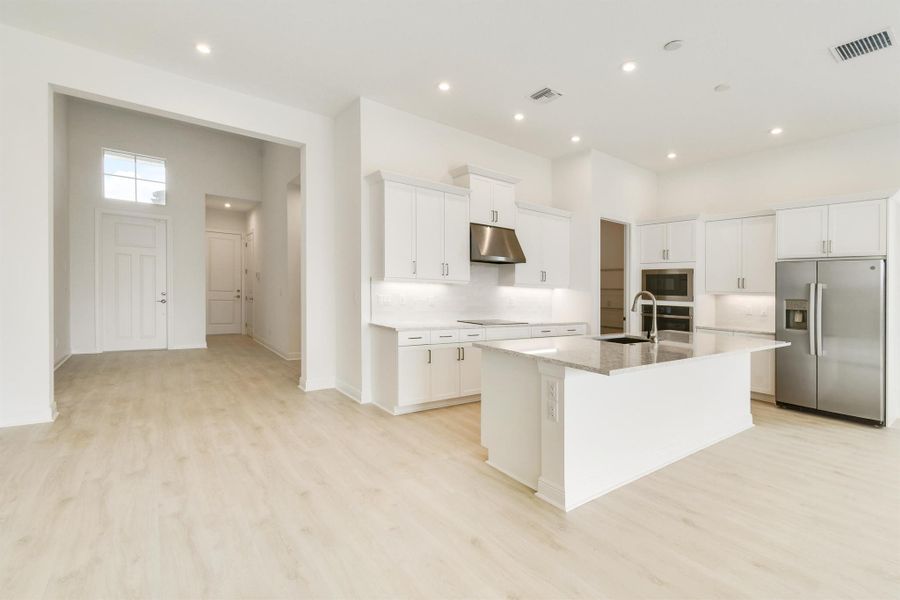 Furnished interior view inside a new home in PGA Village Verano, Port St. Lucie (Image 5).