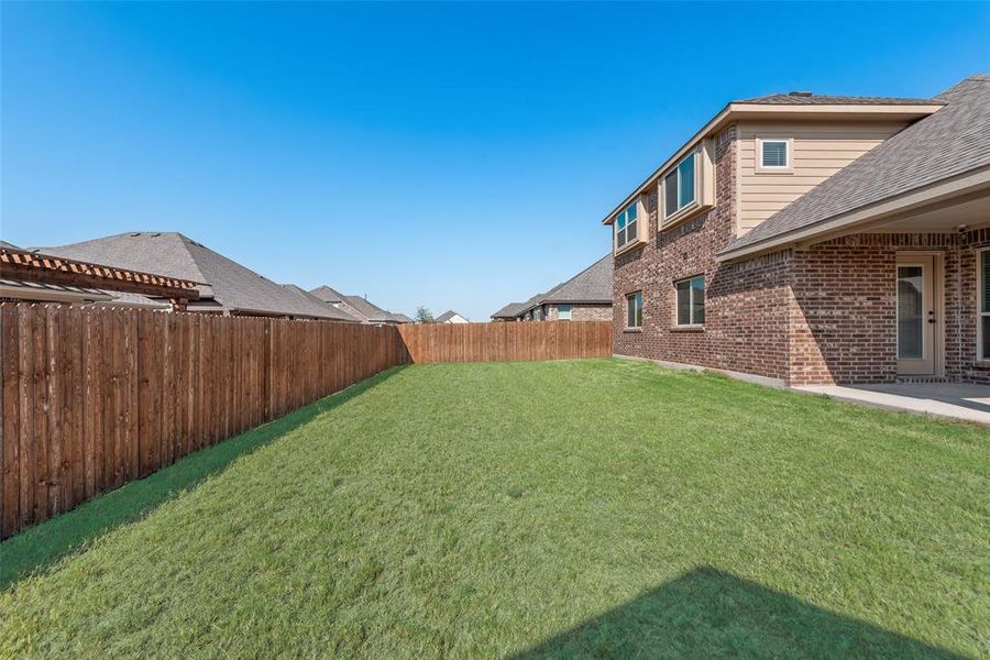 Fenced backyard featuring a patio area Fenced backyard featuring a patio area