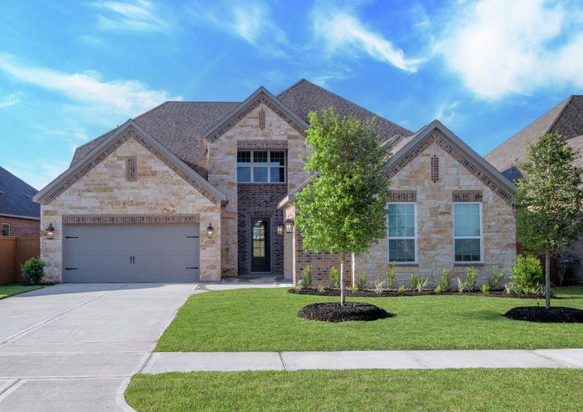 The Orchid is a two-story home has a stunning brick and stone exterior.