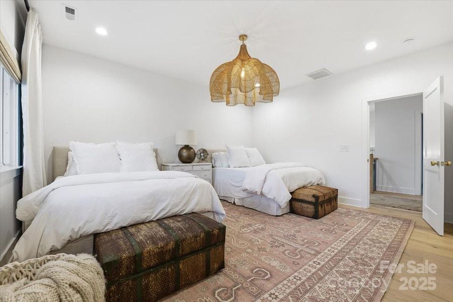 Upstairs secondary bedroom suite (Bedroom #2) with enough room for two Queen sized bed sets, hardwood flooring, ensuite bath and walk in closet. Upstairs secondary bedroom suite (Bedroom #2) with enough room for two Queen sized bed sets, hardwood flooring, ensuite bath and walk in closet.