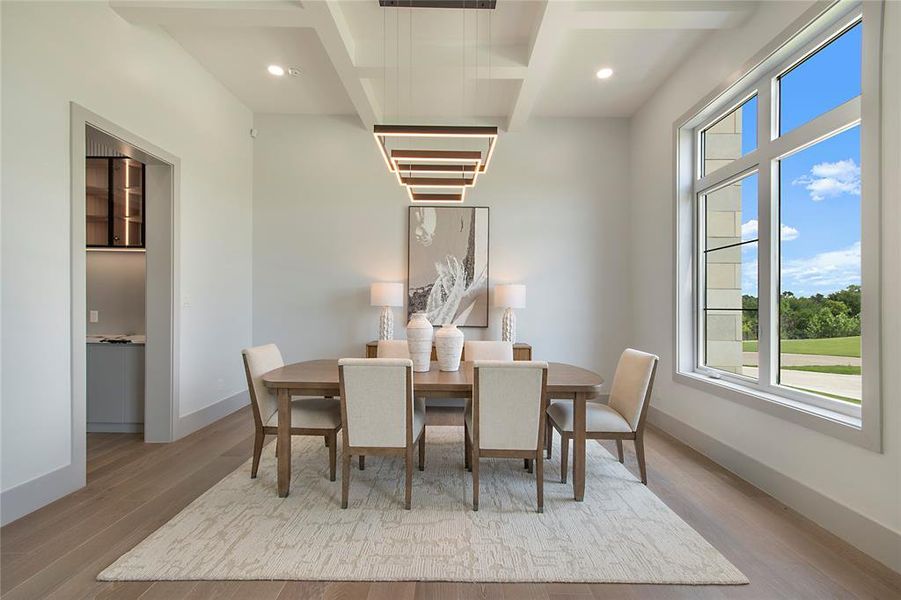 Dining space with healthy amount of natural light, wood finished floors, recessed lighting, and beamed ceiling