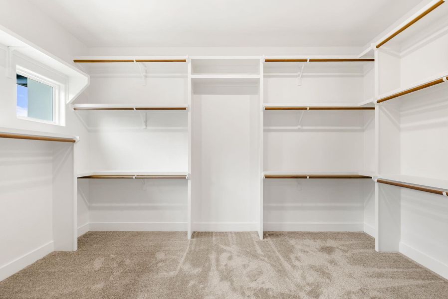 A spacious walk-in closet with ample shelving and hanging space offers organizational possibilities.