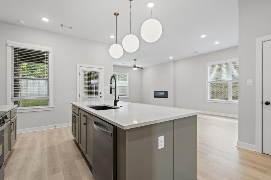 Kitchen featuring open floor plan, recessed lighting, plenty of natural light, light wood-style flooring, and dishwasher