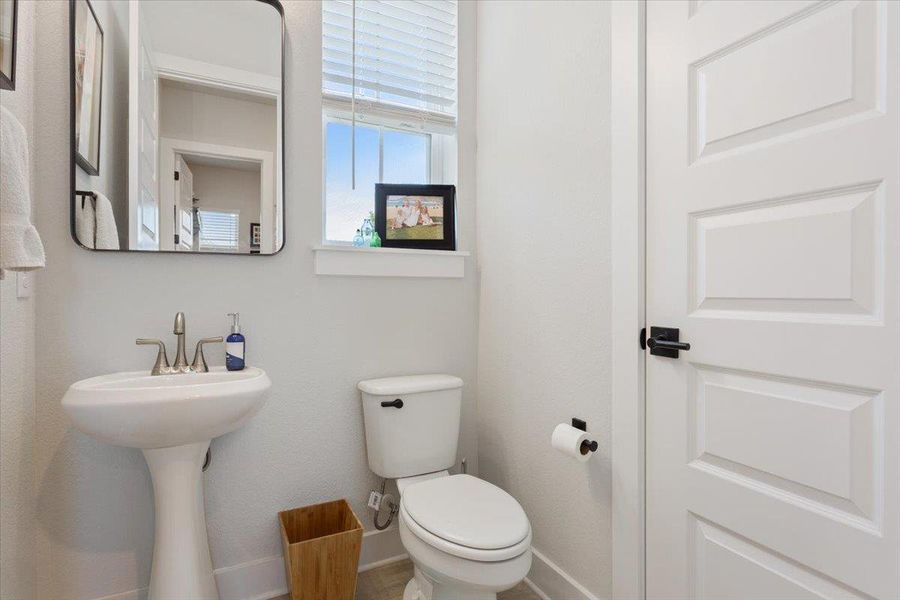 Bathroom with toilet and baseboards