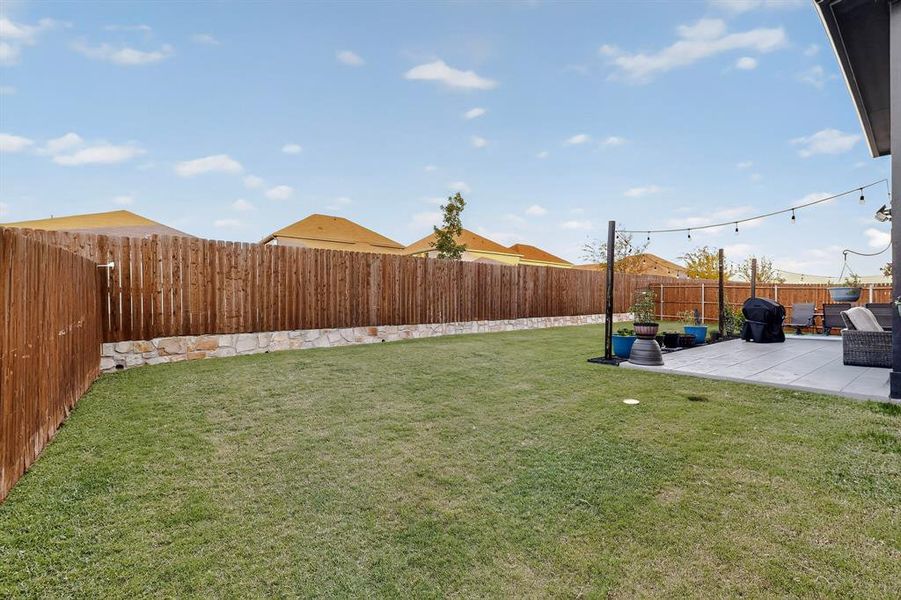 Fenced backyard featuring a patio Fenced backyard featuring a patio