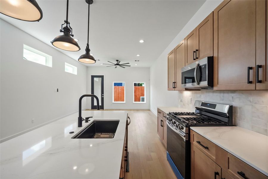 Expansive gourmet kitchen with sleek, modern finishes. Expansive gourmet kitchen with sleek, modern finishes.