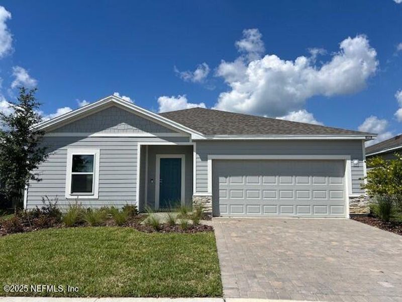 Front exterior of a new home in Coopers Meadow, Jacksonville, FL, highlighting curb appeal (Image 1).