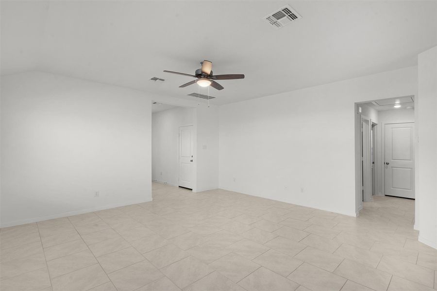 Unfurnished room with a ceiling fan and attic access
