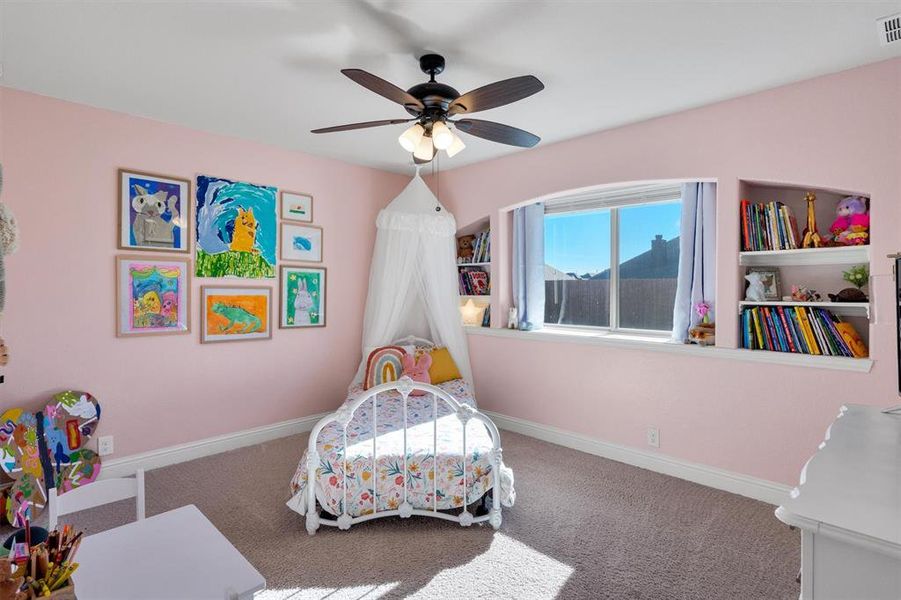 Carpeted bedroom featuring ceiling fan