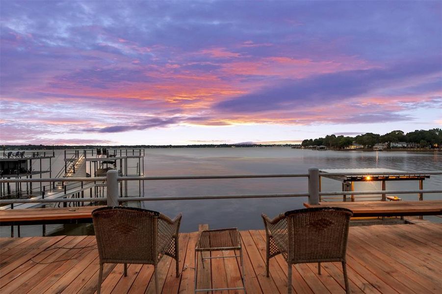 Waterfront deck featuring wood flooring and metal railings