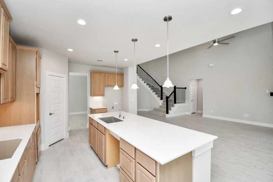 All of this overlooks your expansive family room, creating a perfect space for culinary delights and family gatherings. Sample photo of completed home with similar floor plan. Actual colors and selections may vary.