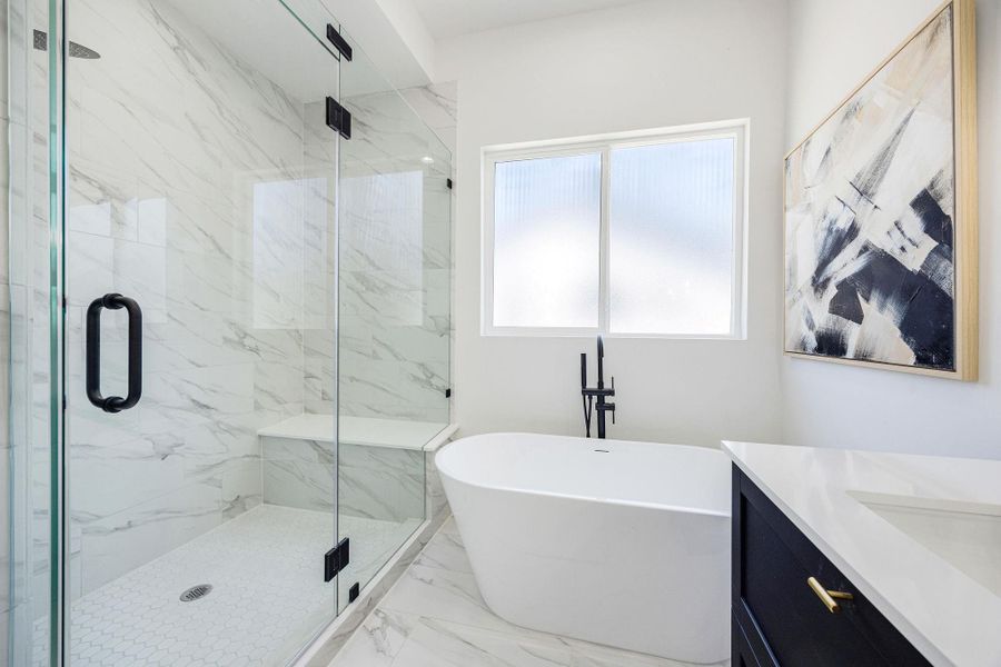 Primary bathroom suit with oversized walk-in shower and free-standing tub.