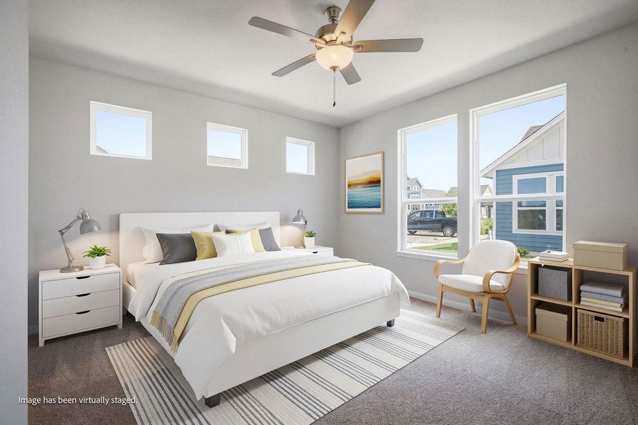Generous windows invite abundant natural light into this modern carpeted bedroom. Generous windows invite abundant natural light into this modern carpeted bedroom.