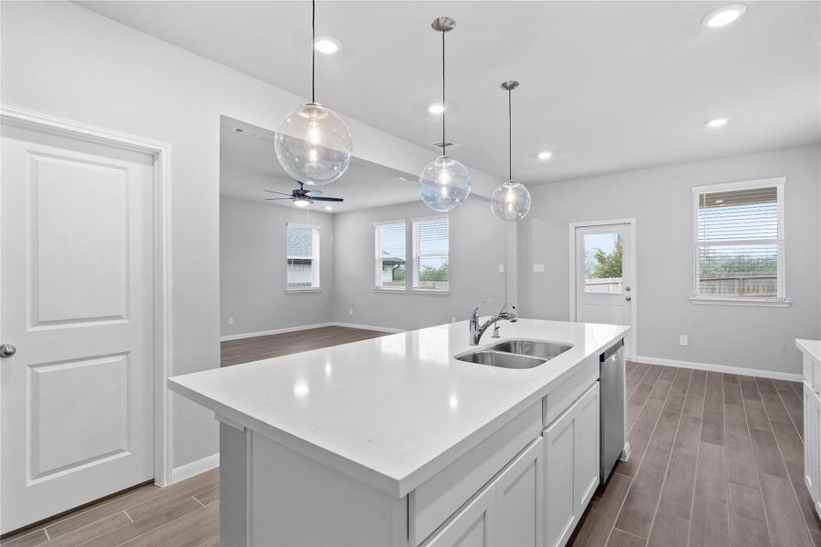 From the expansive kitchen island, enjoy seamless sightlines across the open-concept dining and living areas, making entertaining a breeze and ensuring you're never far from the conversation.