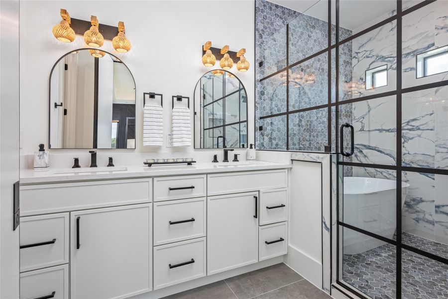 The primary spa bath stuns with dual vanities, accent mirrors, custom lighting, and refined cabinetry with quartz counters.