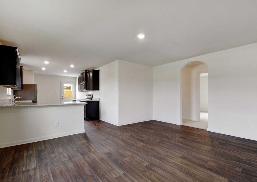 Medina kitchen area and dining nook with ceramic flooring, recessed lights, and dark wood custom cabinets