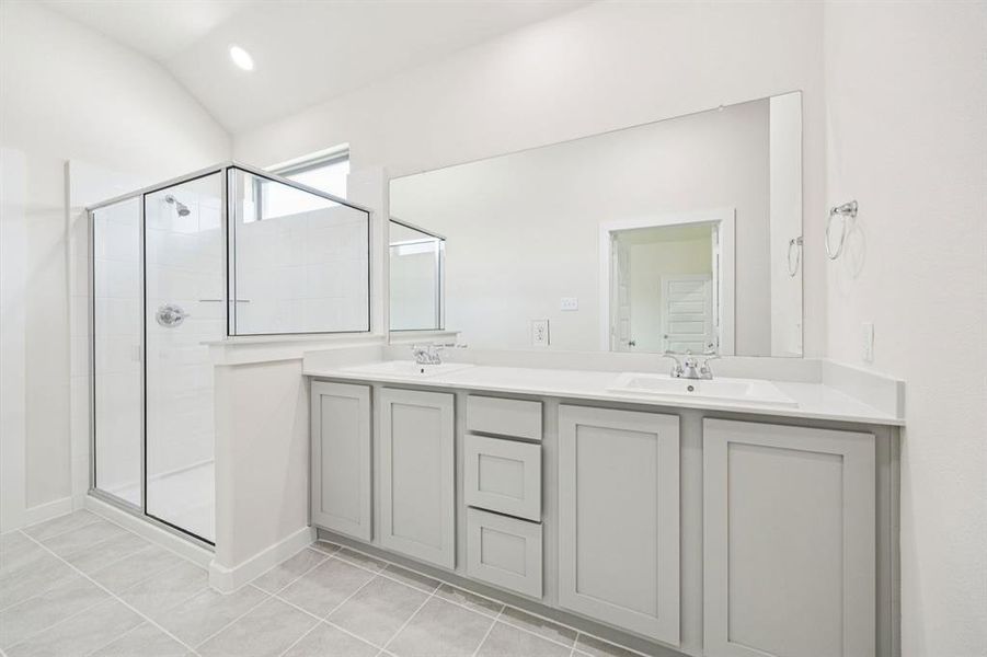 Primary Bathroom in the Claret home plan by Trophy Signature Homes  REPRESENTATIVE PHOTO