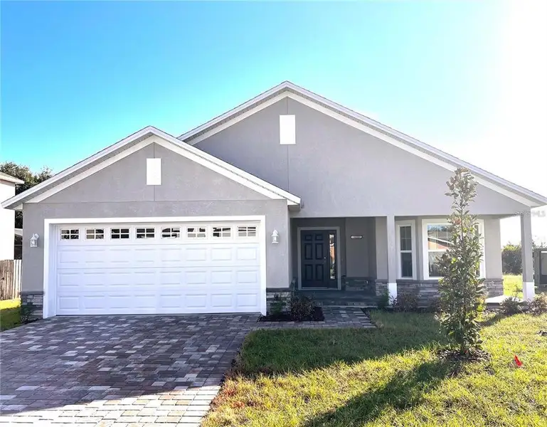 Front exterior of a new home in , Eustis, FL, highlighting curb appeal (Image 1).