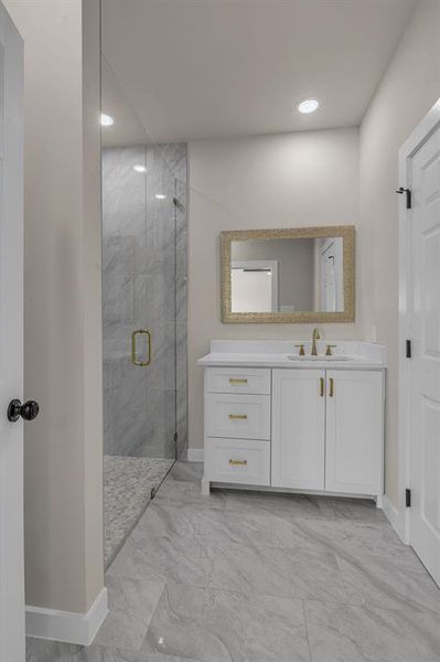 Bathroom with a shower with door and vanity