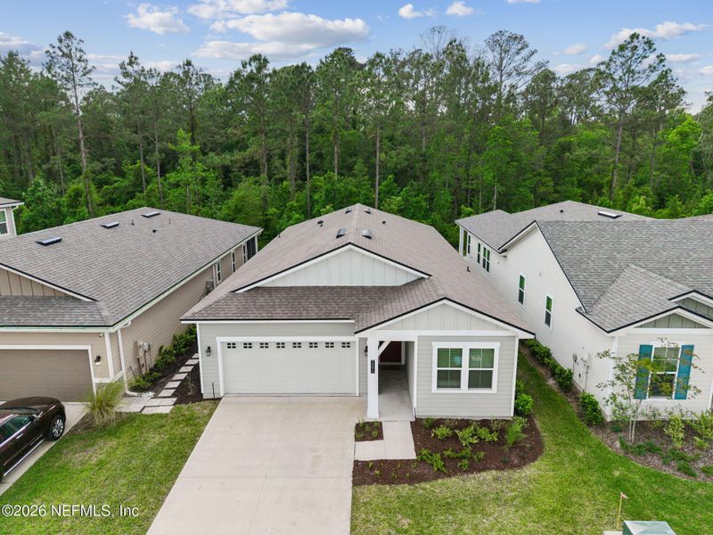 Front exterior of a new home in Tributary, Yulee, FL, highlighting curb appeal (Image 22).