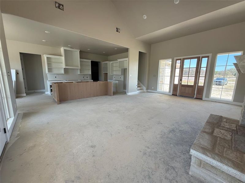 Unfurnished living room with recessed lighting and vaulted ceiling