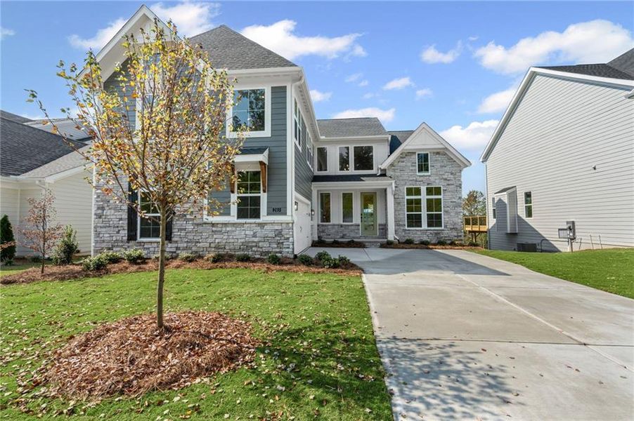 Front exterior of a new home in Twin Lakes, Hoschton, GA, highlighting curb appeal (Image 1).