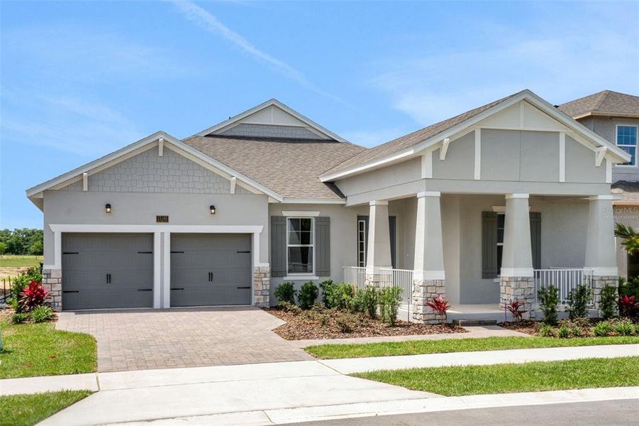 Front exterior of a new home in Avalon Woods, Winter Garden, FL, highlighting curb appeal (Image 1). Front exterior of a new home in Avalon Woods, Winter Garden, FL, highlighting curb appeal (Image 1).
