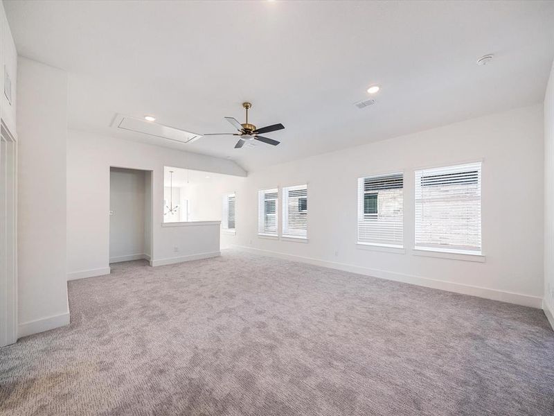 Spare room featuring attic access, light carpet, ceiling fan, and recessed lighting