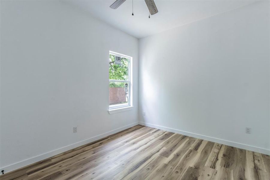 Unfurnished room featuring light wood finished floors, a ceiling fan, and baseboards Unfurnished room featuring light wood finished floors, a ceiling fan, and baseboards