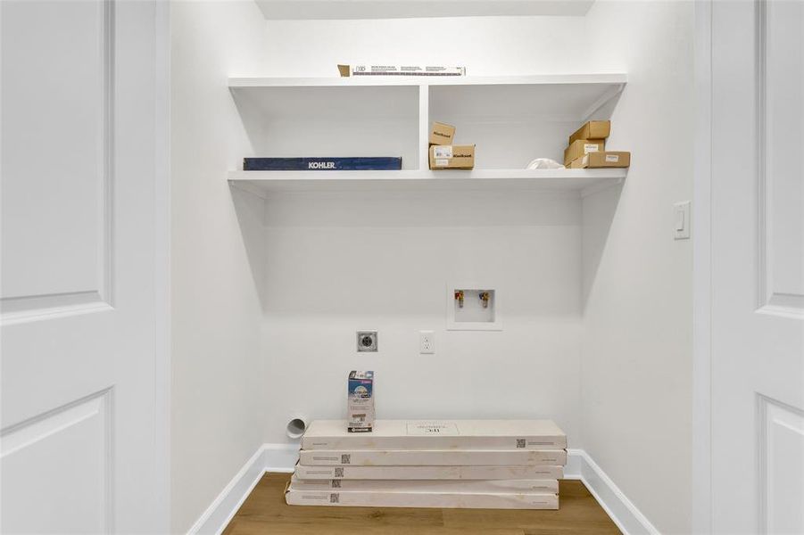 Laundry area with hookup for a washing machine, electric dryer hookup, and wood finished floors Laundry area with hookup for a washing machine, electric dryer hookup, and wood finished floors