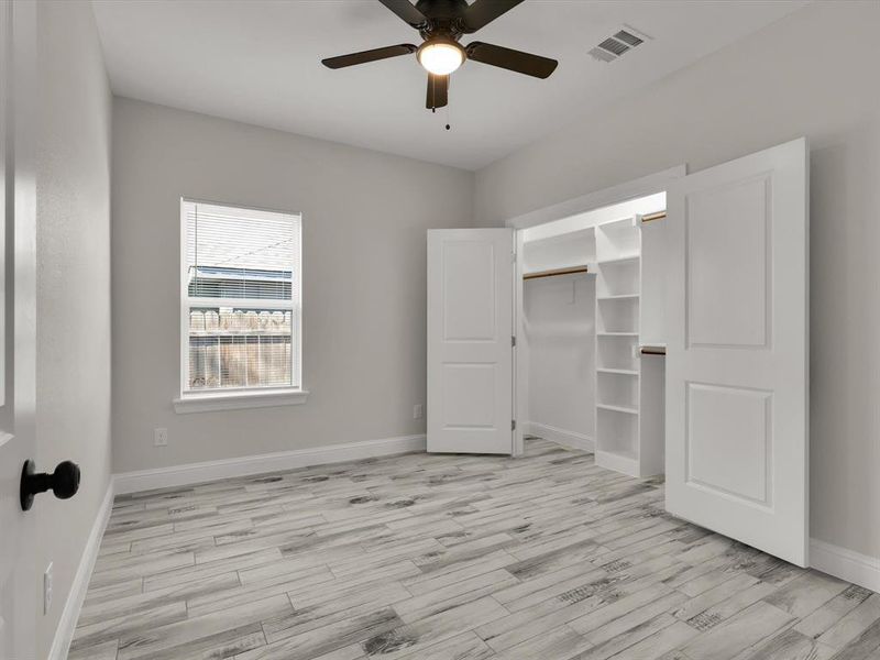 Unfurnished bedroom featuring ceiling fan, light hardwood / wood-style flooring, and a closet