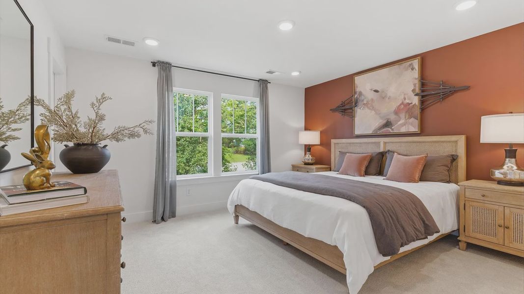 Vibrant natural light fills this exceptional primary suite with eye-catching details at Clarke Townes
