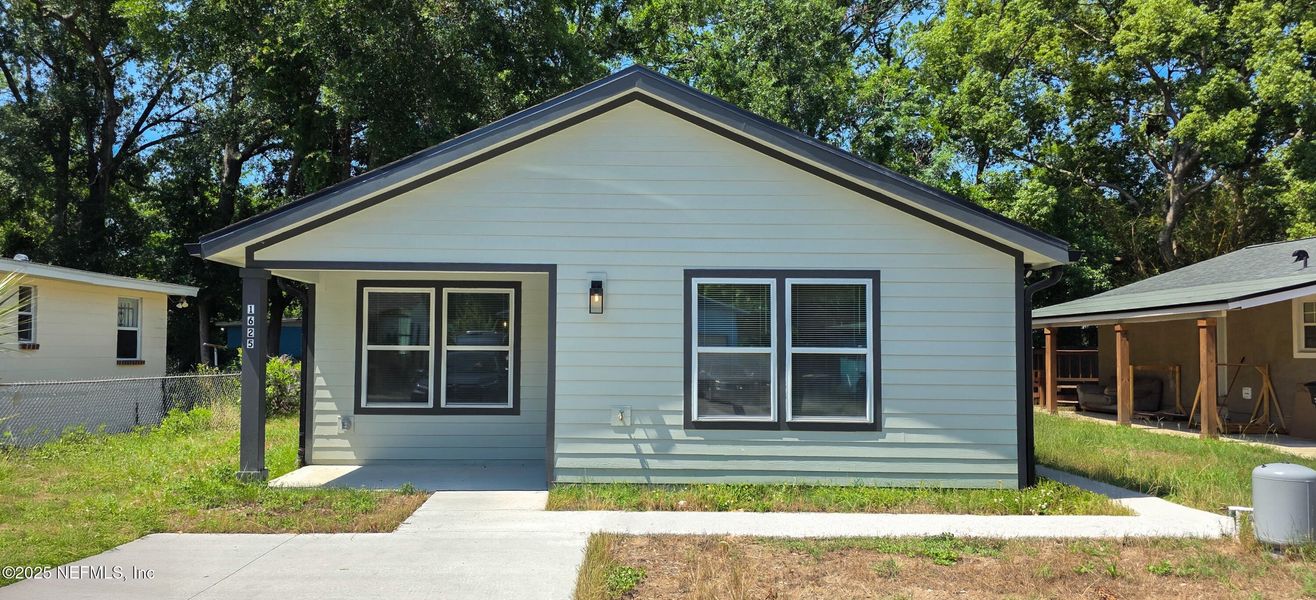 Front exterior of a new home in , Jacksonville, FL, highlighting curb appeal (Image 1).