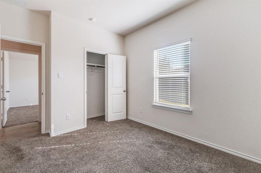 Unfurnished bedroom featuring carpet and a closet Unfurnished bedroom featuring carpet and a closet