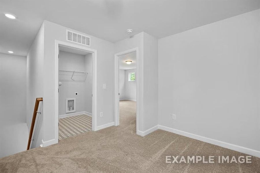 Unfurnished room with light colored carpet