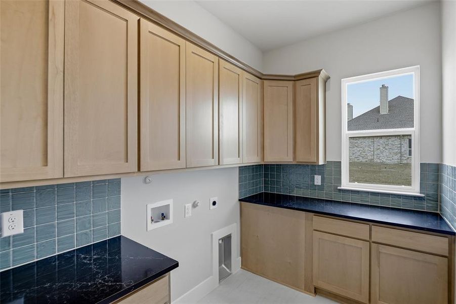 Laundry room featuring hookup for a washing machine, hookup for an electric dryer, hookup for a gas dryer, and cabinet space