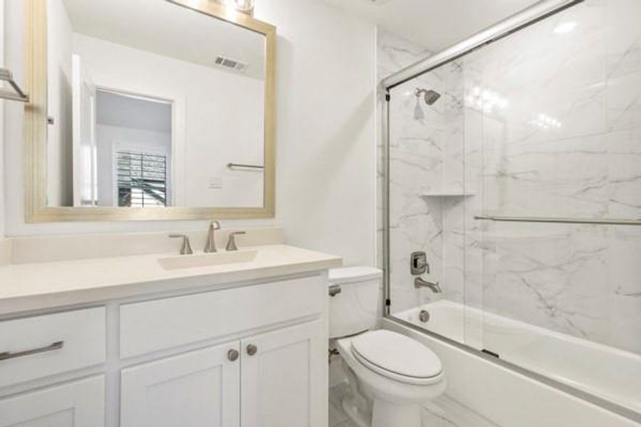 Full bath with combined bath / shower with glass door and vanity Full bath with combined bath / shower with glass door and vanity