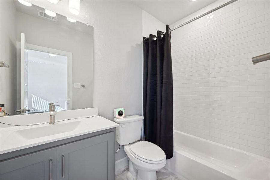 Full bathroom with vanity, toilet, and shower / bath combo