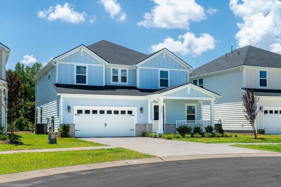 Front exterior of a new home in The Coves at Lakes of Cane Bay, Summerville, SC, highlighting curb appeal (Image 2). Front exterior of a new home in The Coves at Lakes of Cane Bay, Summerville, SC, highlighting curb appeal (Image 2).
