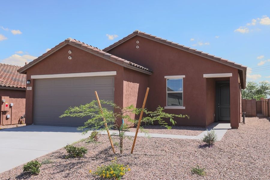 Front exterior of a new home in Entrada Del Pueblo at Rancho Sahuarita, Sahuarita, AZ, highlighting curb appeal (Image 1). Front exterior of a new home in Entrada Del Pueblo at Rancho Sahuarita, Sahuarita, AZ, highlighting curb appeal (Image 1).