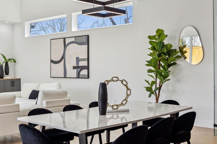 Dining space with plenty of natural light and light hardwood / wood-style flooring