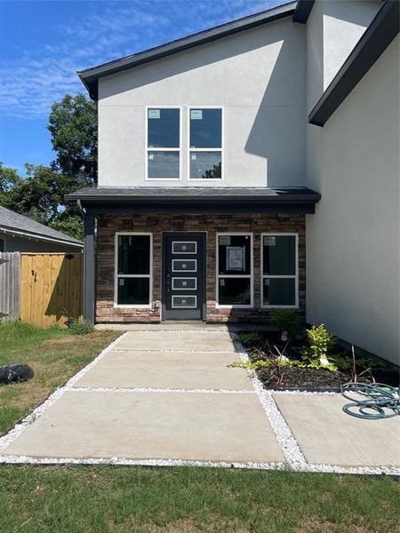 View of front of property featuring stucco siding and a porch View of front of property featuring stucco siding and a porch