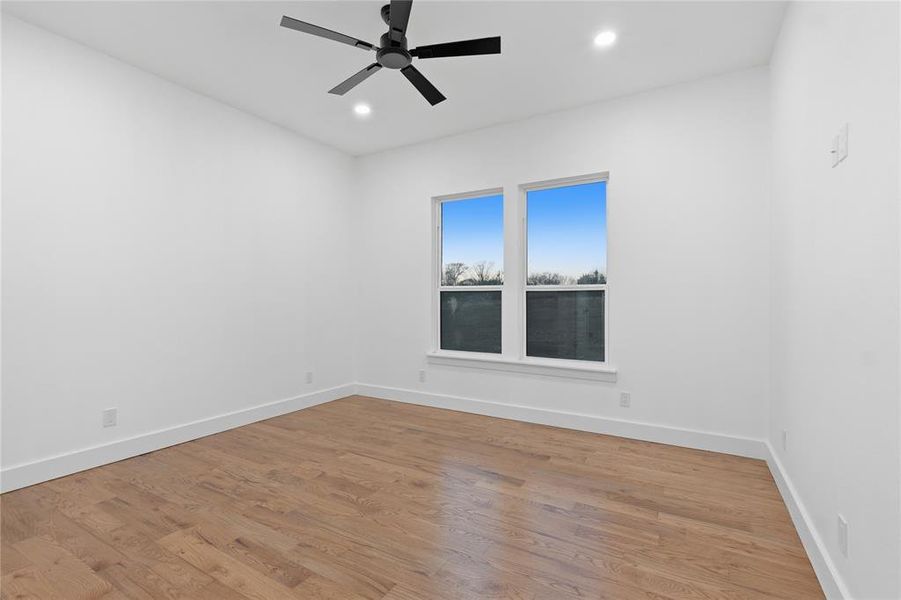 Unfurnished room featuring wood finished floors, a ceiling fan, and recessed lighting