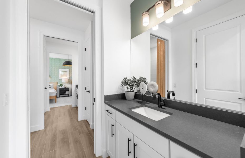 Jack and Jill style bathroom with private sinks