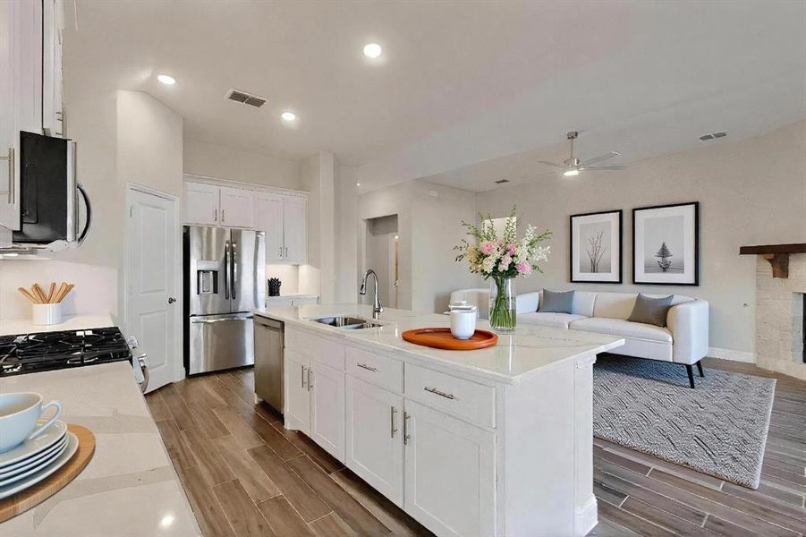Kitchen with white cabinets, wood tiled floors, open floor plan, and recessed lighting